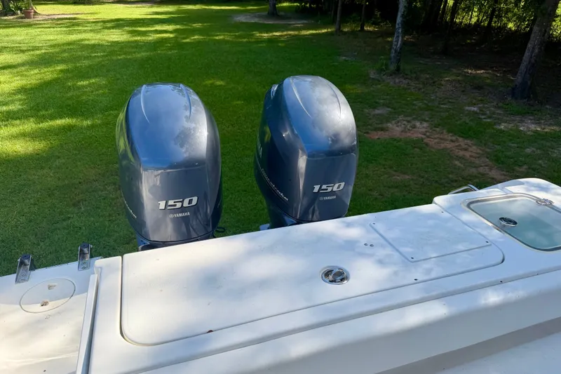 Slide: The Image of 2013 Sea Hunt Gamefish 27 with twin Yamaha 150 engines on grassy background. - 13