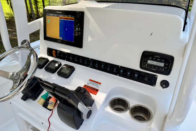Slide: The Image of 2013 Sea Hunt Gamefish 27 dashboard with navigation system and controls. - 12