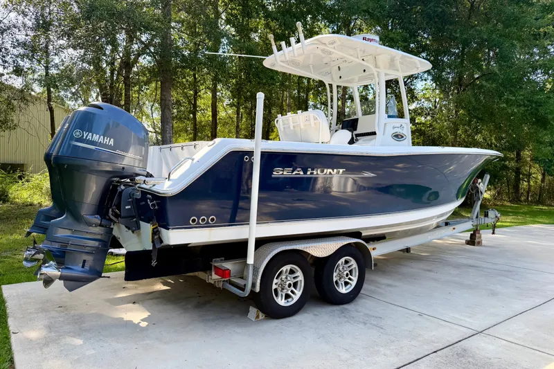 Slide: The Image of 2013 Sea Hunt Gamefish 27 boat on trailer with Yamaha engine, parked outdoors. - 3