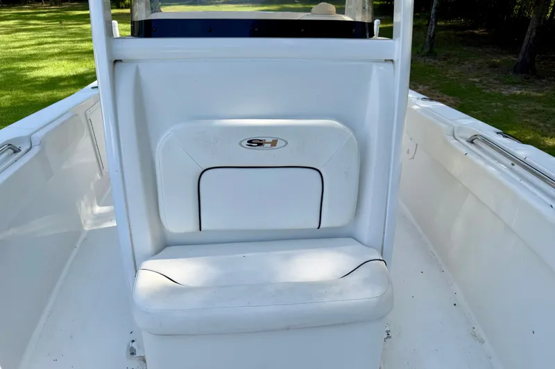 Slide: The Image of 2013 Sea Hunt Gamefish 27 boat interior with white seating and storage compartment. - 5