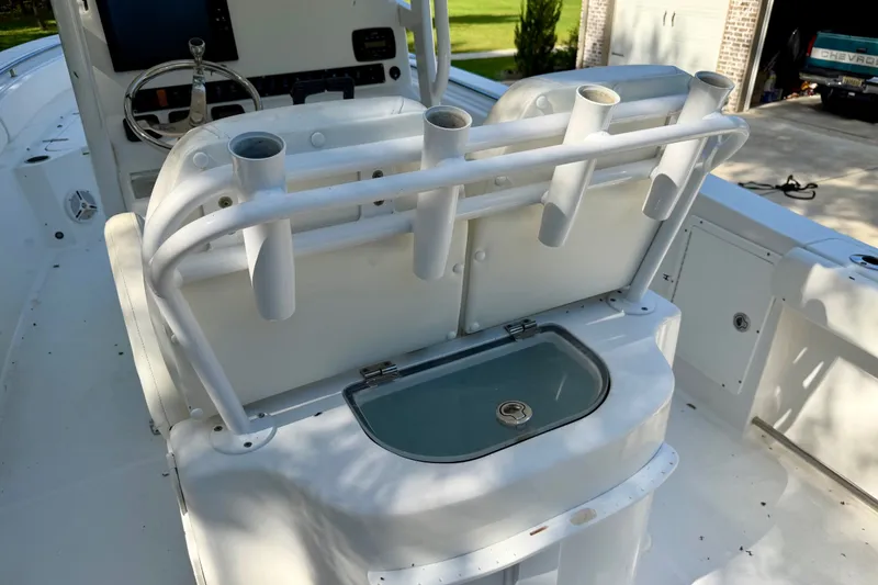 Slide: The Image of 2013 Sea Hunt Gamefish 27 boat interior with rod holders and livewell. - 7