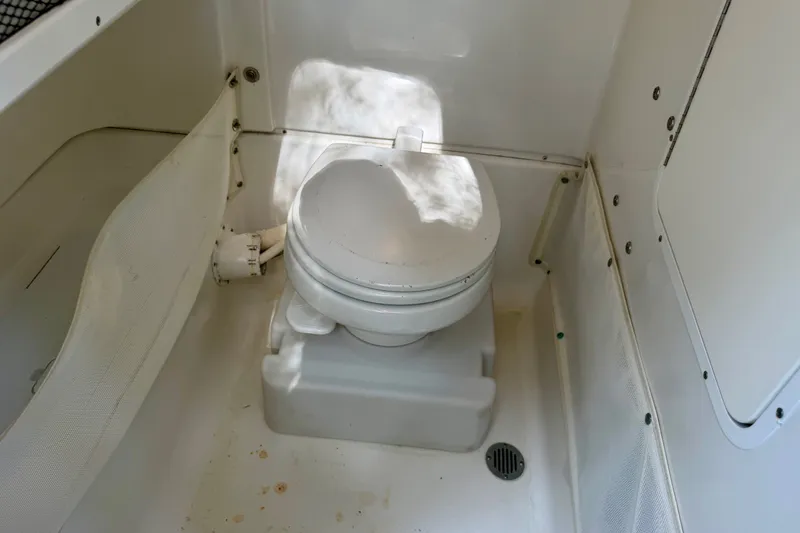 Slide: The Image of 2013 Sea Hunt Gamefish 27 boat interior with marine toilet. - 9