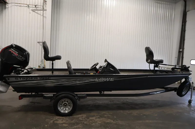 Slide: The Image of 2021 Lowe Stinger 195C fishing boat with Mercury Pro XS engine in a garage. - 3