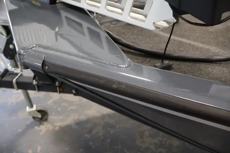 Slide: The Image of 2021 Lowe Stinger 195C boat trailer detail with gray finish and sturdy construction. - 44