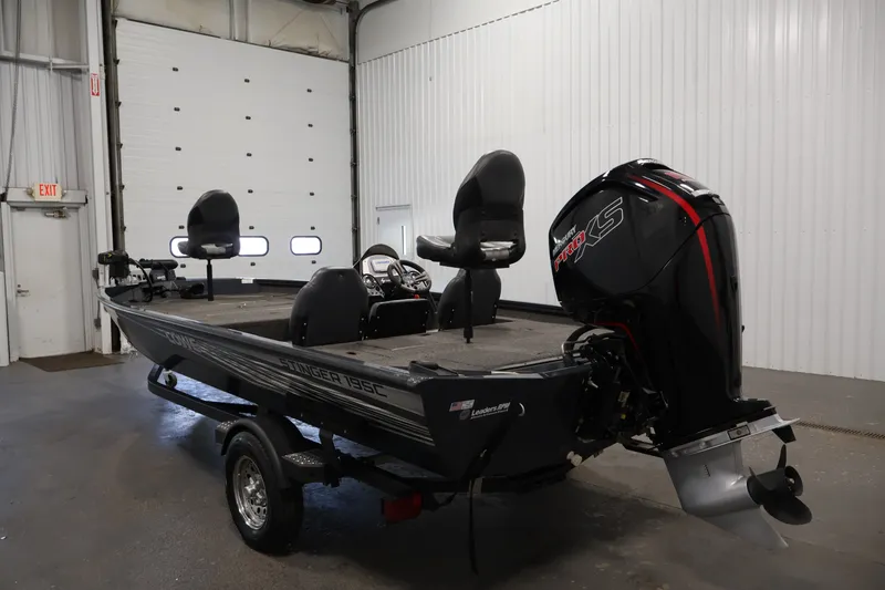 Slide: The Image of 2021 Lowe Stinger 195C fishing boat with powerful outboard motor in a garage setting. - 6