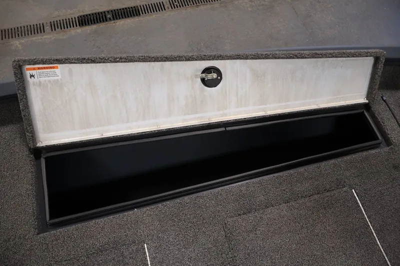 Slide: The Image of Open storage compartment on 2021 Lowe Stinger 195C boat, showcasing interior space. - 16