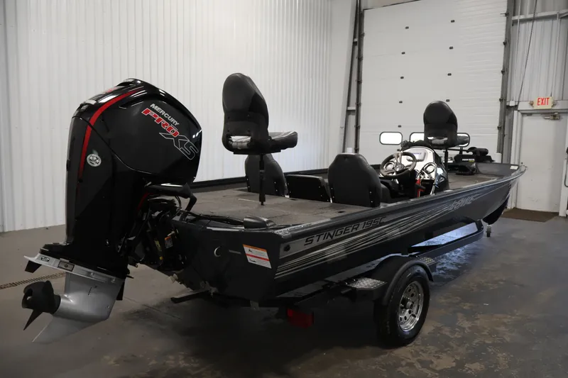Slide: The Image of 2021 Lowe Stinger 195C fishing boat with Mercury Pro XS engine in a garage. - 4