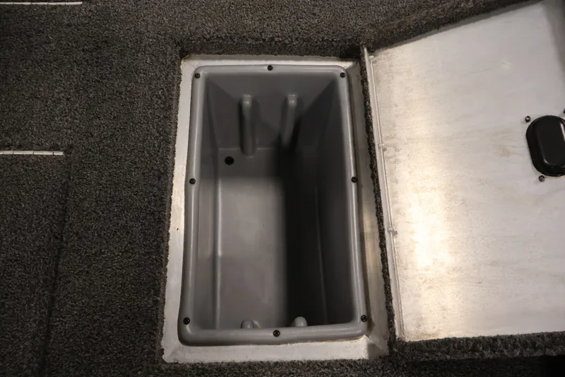 Slide: The Image of Open storage compartment in 2021 Lowe Stinger 195C boat, featuring carpeted interior. - 32