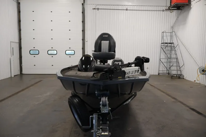 Slide: The Image of 2021 Lowe Stinger 195C boat in a garage, front view with trailer. - 1