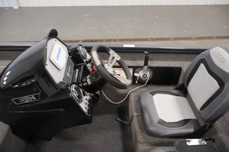 Slide: The Image of 2021 Lowe Stinger 195C boat cockpit with steering wheel and control panel. - 20