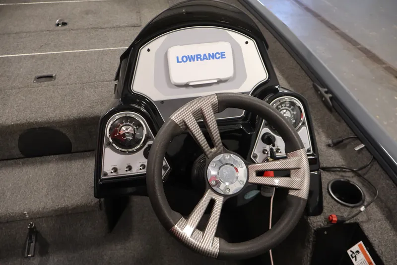 Slide: The Image of 2021 Lowe Stinger 195C boat dashboard with steering wheel and Lowrance display. - 21