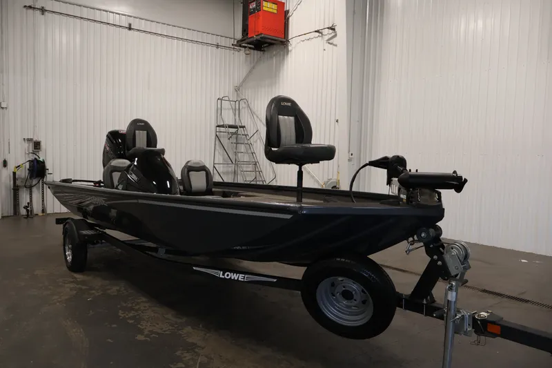 Slide: The Image of 2021 Lowe Stinger 195C fishing boat in a garage setting. - 2