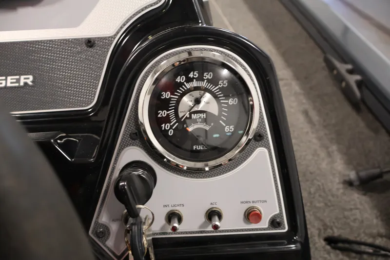 Slide: The Image of Dashboard of a 2021 Lowe Stinger 195C boat with speedometer and controls. - 23