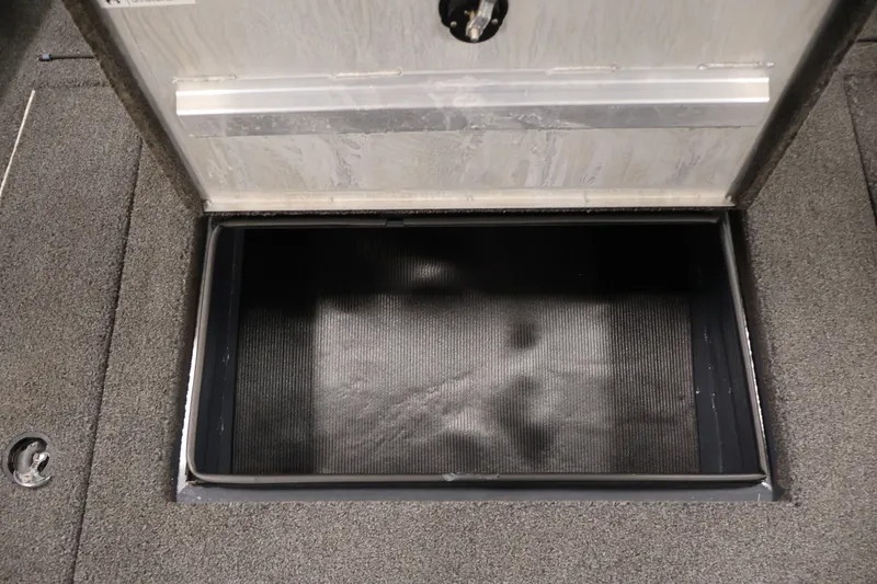Slide: The Image of Open storage compartment on 2021 Lowe Stinger 195C boat deck. - 17