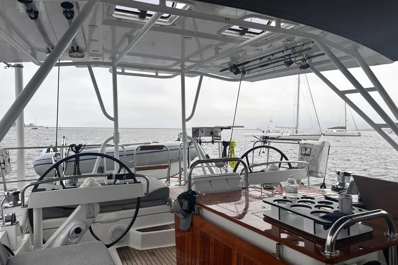 Slide: The Image of Interior view of 2012 Jeanneau 57 yacht with dual steering wheels and ocean backdrop. - 33