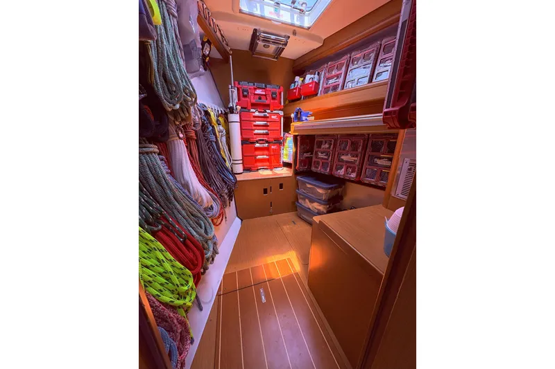Slide: The Image of Interior of 2012 Jeanneau 57 yacht with organized ropes and storage compartments. - 44