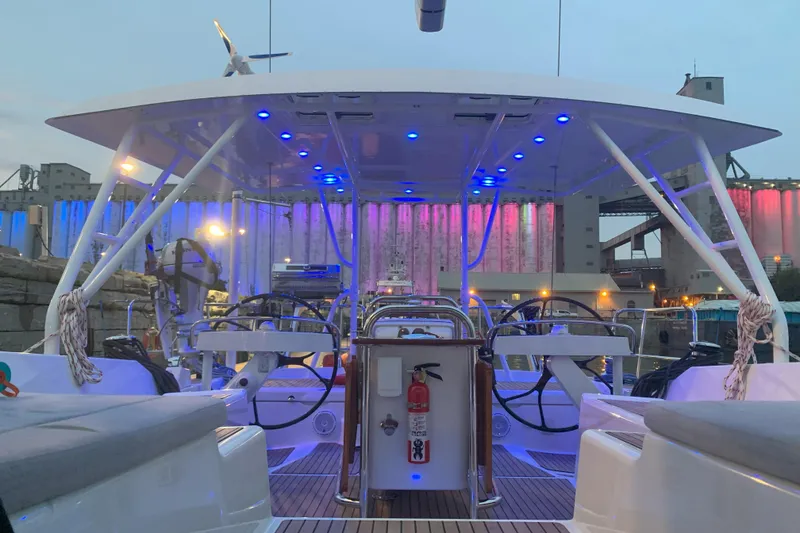 Slide: The Image of 2012 Jeanneau 57 yacht deck with blue LED lights and dual steering wheels. - 21
