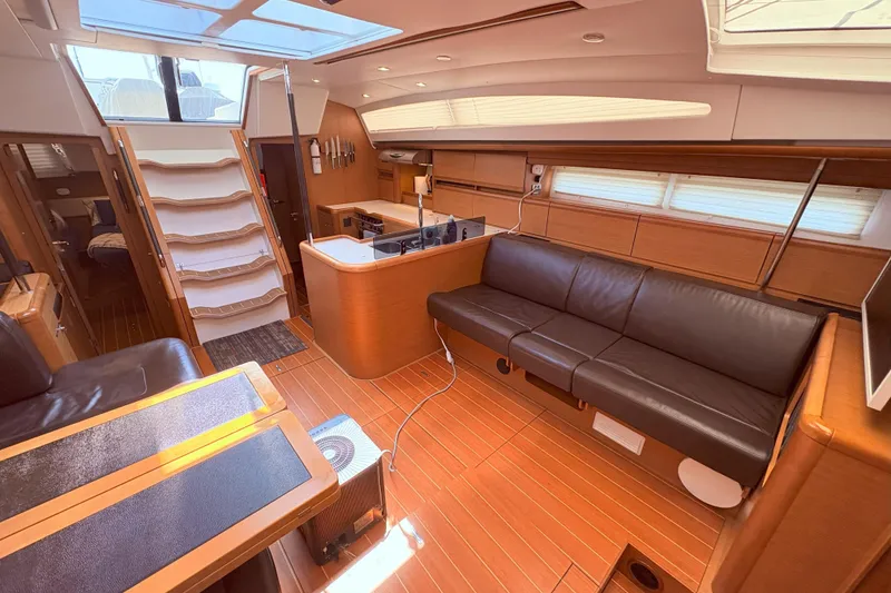 Slide: The Image of Luxurious interior of a 2012 Jeanneau 57 yacht with modern furnishings and ample natural light. - 51