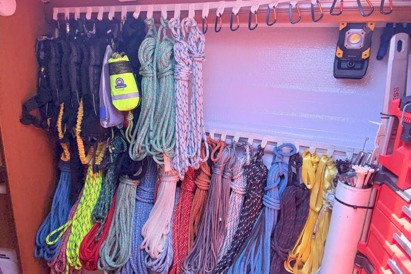 Slide: The Image of Organized ropes and gear storage on a 2012 Jeanneau 57 sailboat. - 39