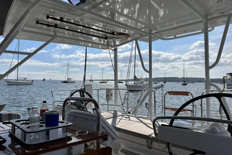Slide: The Image of View from Jeanneau 57 yacht, overlooking a serene harbor with sailboats and blue sky. - 32