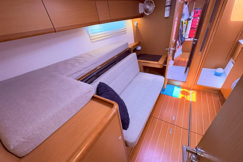 Slide: The Image of Interior of 2012 Jeanneau 57 yacht with cozy seating and wooden flooring. - 45