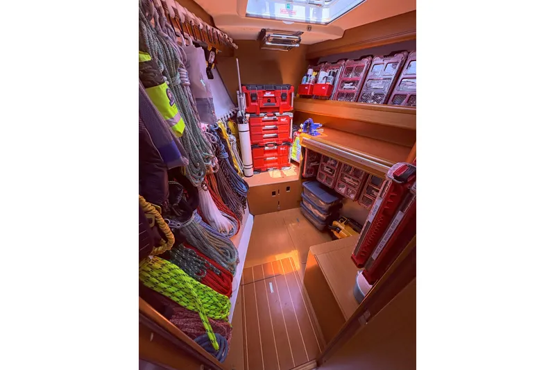 Slide: The Image of Storage area on a 2012 Jeanneau 57 yacht, organized with ropes and toolboxes. - 43