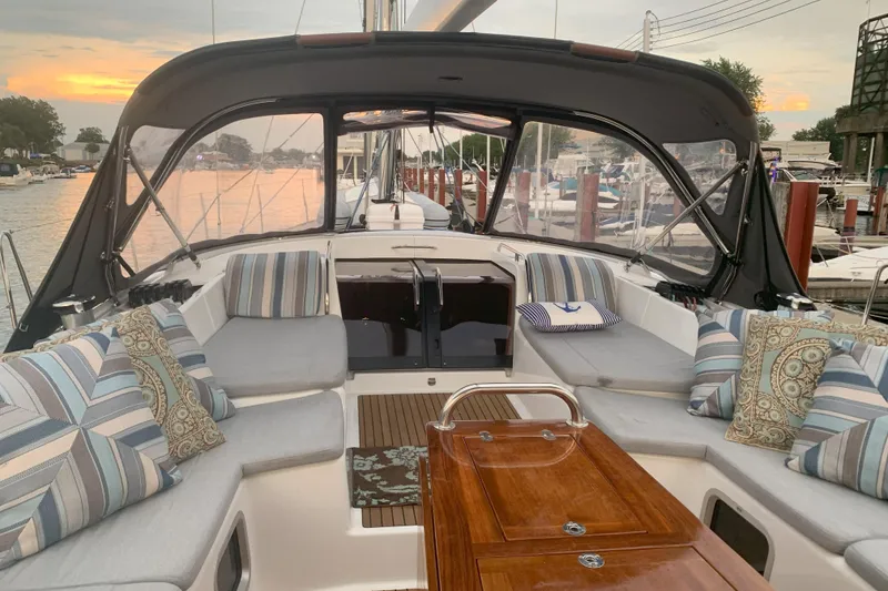 Slide: The Image of Luxurious 2012 Jeanneau 57 yacht interior with elegant seating and sunset view. - 18
