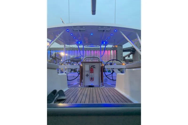 Slide: The Image of 2012 Jeanneau 57 yacht cockpit with blue LED lights and dual steering wheels. - 20