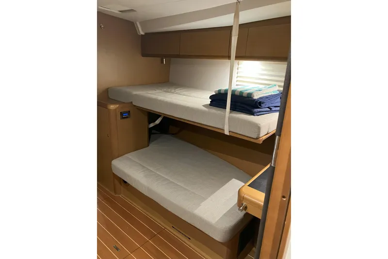 Slide: The Image of Interior of 2012 Jeanneau 57 yacht with cozy bunk beds and wooden finish. - 54