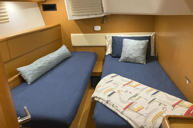 Slide: The Image of Cozy cabin interior of 2012 Jeanneau 57 yacht with twin beds and nautical decor. - 53