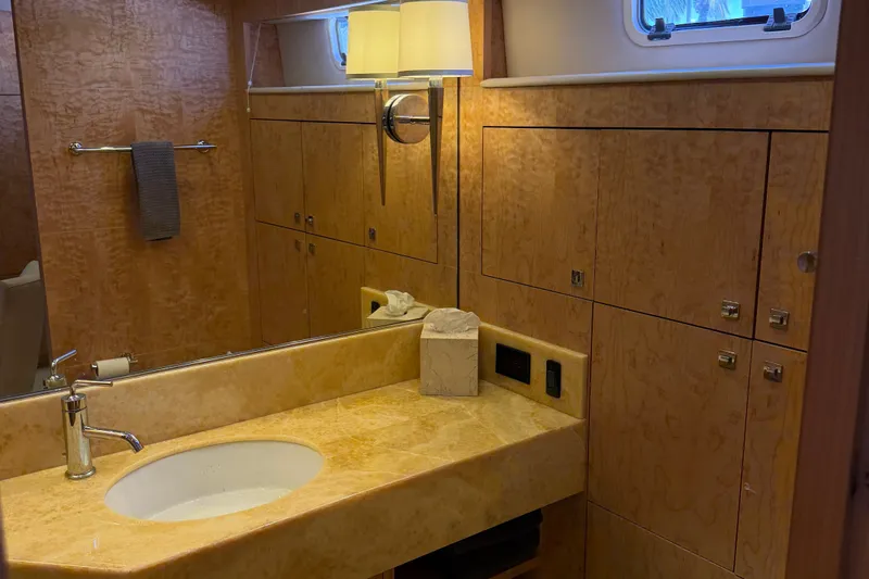 Slide: The Image of Luxurious bathroom interior on a 2011 Pedigree Cat Sportfish Catamaran, featuring elegant wood cabinetry. - 37