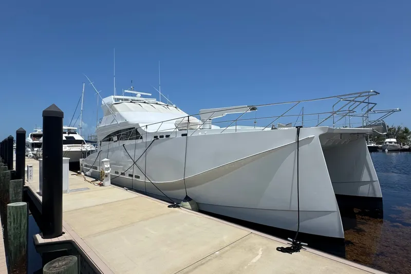 Slide: The Image of 2011 Pedigree Cat Sportfish Catamaran docked at marina under clear blue sky. - 2
