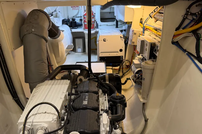 Slide: The Image of Engine room of a 2011 Pedigree Cat Sportfish Catamaran, showcasing machinery and wiring. - 67