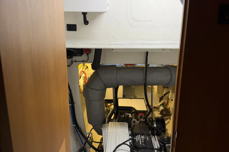 Slide: The Image of Engine room of a 2011 Pedigree Cat Sportfish Catamaran, showcasing mechanical components. - 68