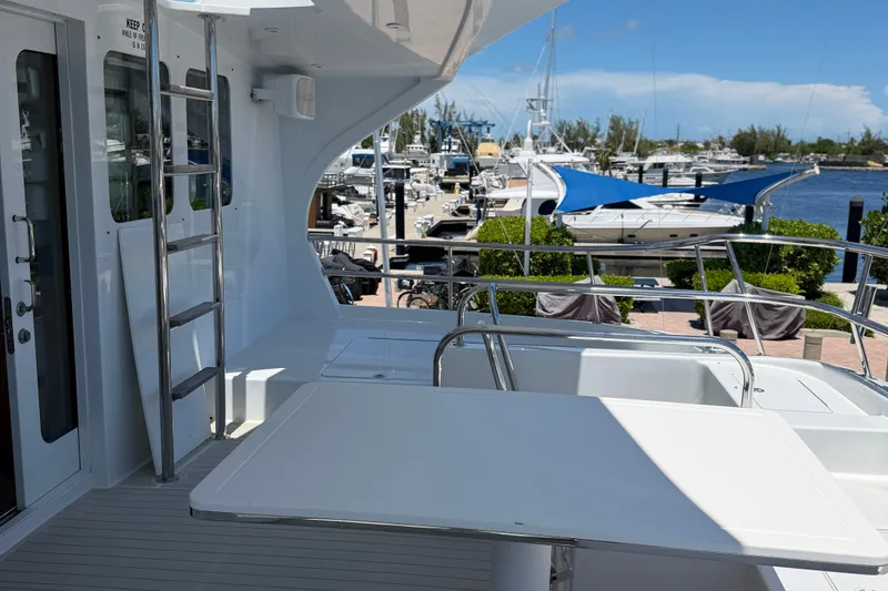 Slide: The Image of 2011 Pedigree Cat Sportfish Catamaran docked, featuring sleek deck design and marina view. - 11