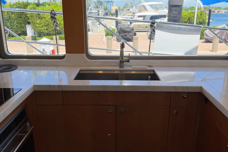 Slide: The Image of Interior view of 2011 Pedigree Cat Sportfish Catamaran kitchen with sink and countertop. - 26