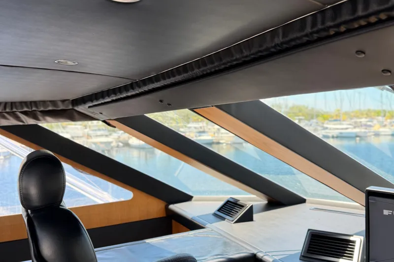 Slide: The Image of Interior view of 2011 Pedigree Cat Sportfish Catamaran, featuring sleek design and marina backdrop. - 14