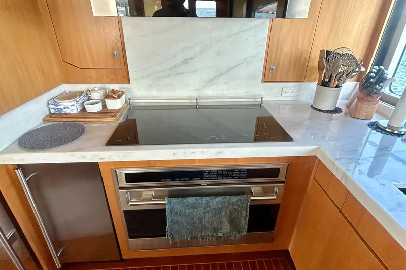 Slide: The Image of Modern kitchen in 2011 Pedigree Cat Sportfish Catamaran with sleek appliances and marble countertops. - 25