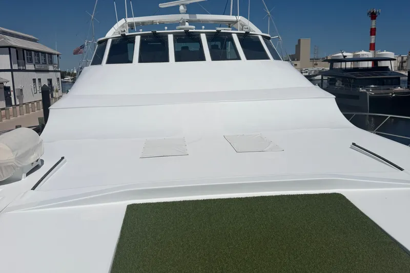 Slide: The Image of 2011 Pedigree Cat Sportfish Catamaran docked, showcasing sleek white deck and modern design. - 7