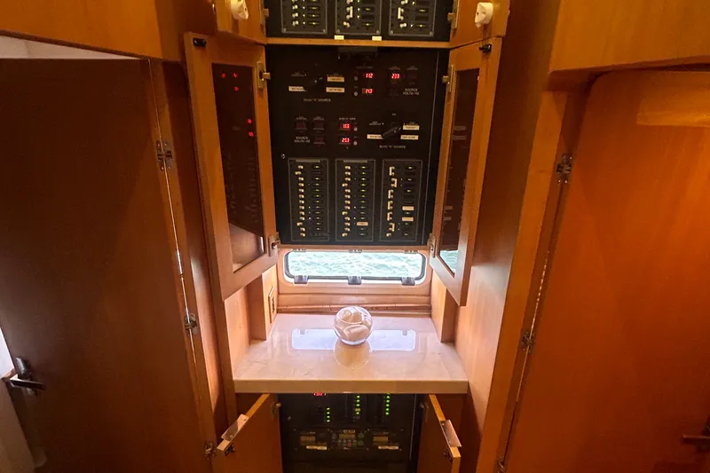 Slide: The Image of Electrical panel inside 2011 Pedigree Cat Sportfish Catamaran with wooden cabinetry. - 65
