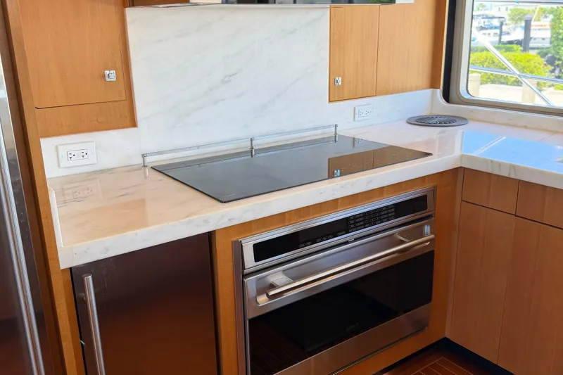 Slide: The Image of Modern kitchen in 2011 Pedigree Cat Sportfish Catamaran with sleek appliances and marble countertops. - 24