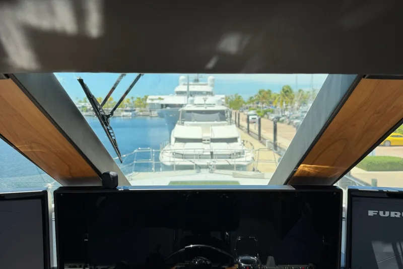 Slide: The Image of View from the helm of a 2011 Pedigree Cat Sportfish Catamaran, docked at a marina. - 16