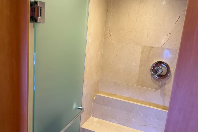 Slide: The Image of Luxurious shower area in 2011 Pedigree Cat Sportfish Catamaran with marble tiles and glass door. - 51