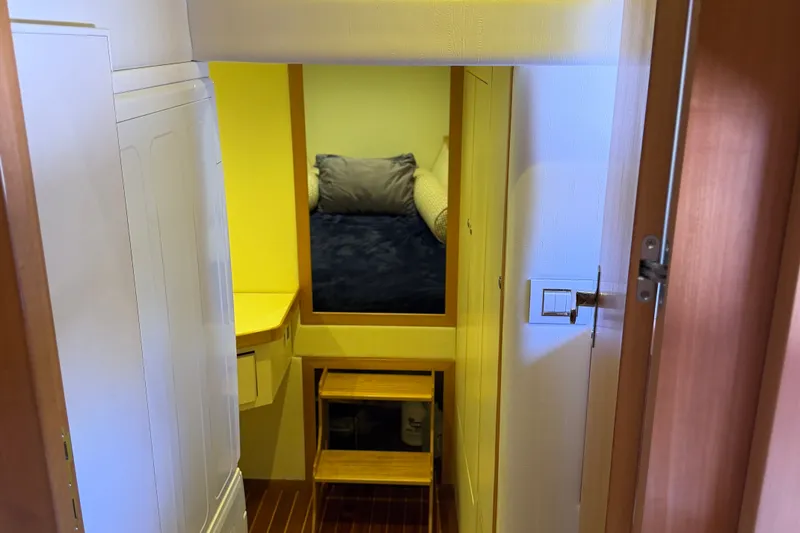 Slide: The Image of Interior cabin of 2011 Pedigree Cat Sportfish Catamaran with cozy bed and wooden accents. - 55