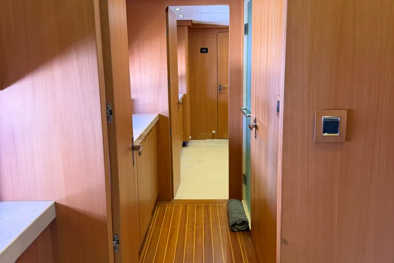 Slide: The Image of Interior hallway of 2011 Pedigree Cat Sportfish Catamaran with wooden paneling and modern design. - 57