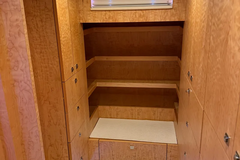Slide: The Image of Wooden storage shelves and cabinets inside a 2011 Pedigree Cat Sportfish Catamaran. - 43