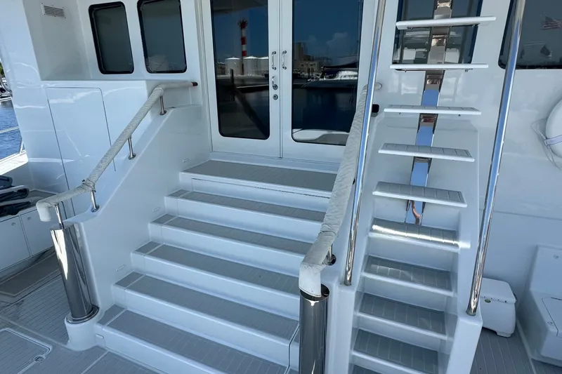 Slide: The Image of Staircase on 2011 Pedigree Cat Sportfish Catamaran, featuring sleek design and polished railings. - 6