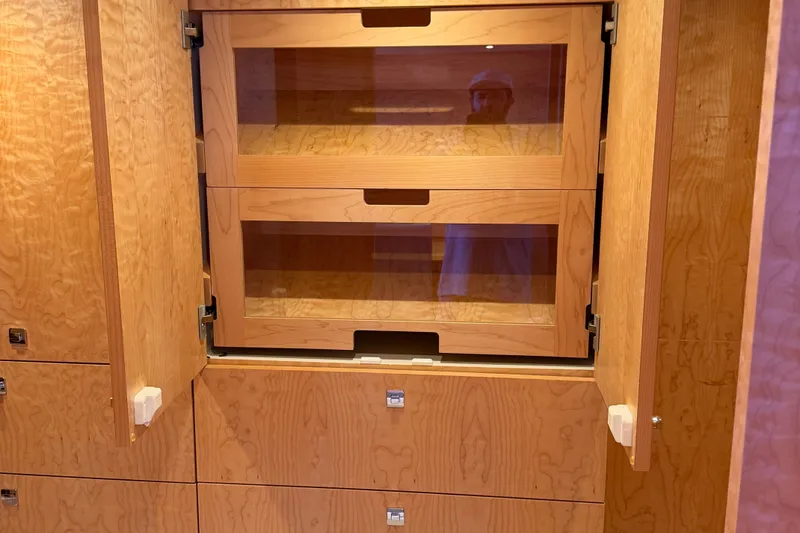 Slide: The Image of Wooden cabinetry with glass doors inside a 2011 Pedigree Cat Sportfish Catamaran. - 44