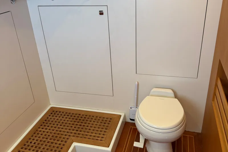 Slide: The Image of 2011 Pedigree Cat Sportfish Catamaran bathroom with toilet and wooden floor accents. - 62