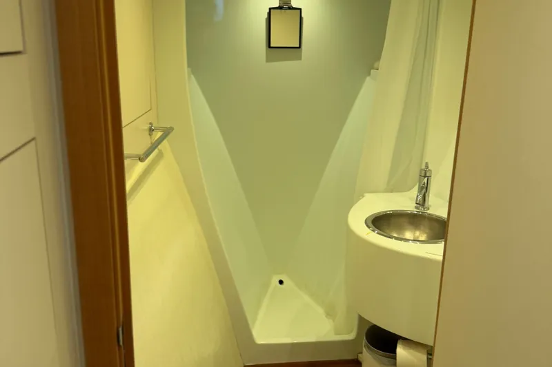 Slide: The Image of Compact bathroom in 2011 Pedigree Cat Sportfish Catamaran with modern sink and shower. - 48